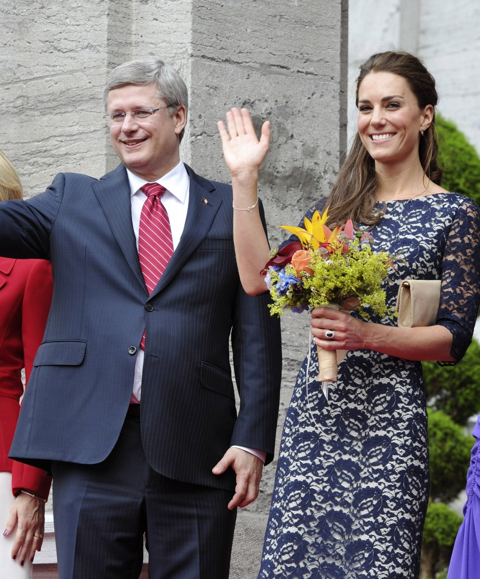 Britains Catherine, Duchess of Cambridge, waves as she stands with Canadas Prime Minister Stephen Harper in Ottawa