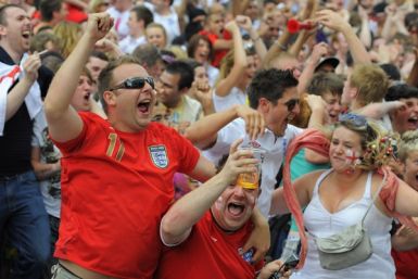England fans react after a goal while watching the World Cup soccer match between England and Slovenia on a big screen in Leeds