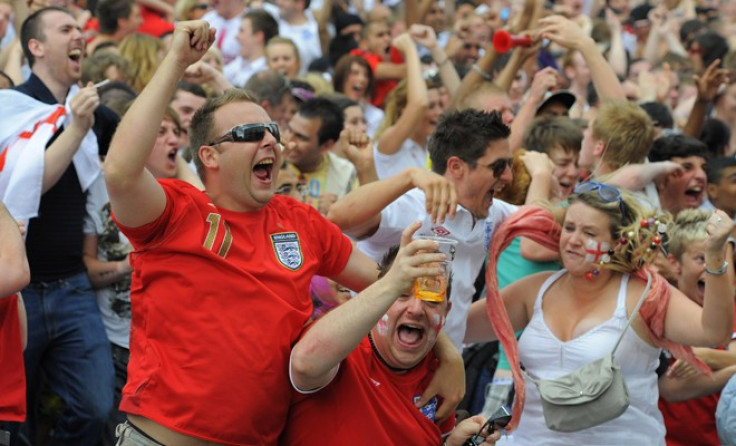 England fans react after a goal while watching the World Cup soccer match between England and Slovenia on a big screen in Leeds