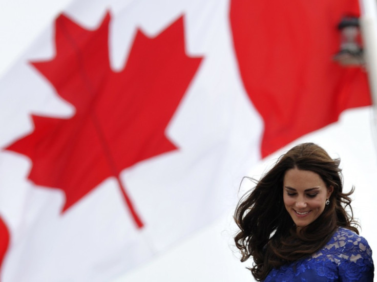Britain's Prince William and his wife Catherine, Duchess of Cambridge, take part in a trick during a tour of the Maison Dauphine in Quebec City July 3, 2011.