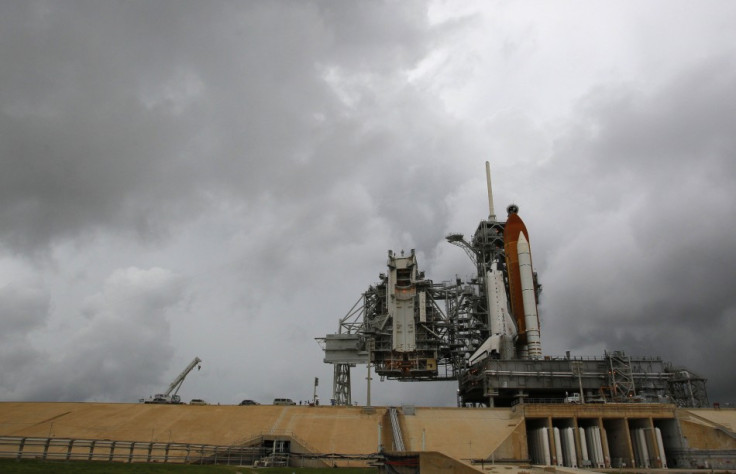 The space shuttle Atlantis is shown on launch pad 39A under dark skies after the Rotating Service Structure was rolled back at the Kennedy Space Center in Cape Canaveral