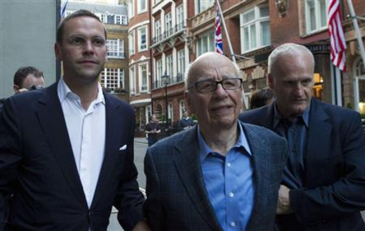 James and Rupert Murdoch and a minder leave the Stafford Hotel in St James's Place, central London