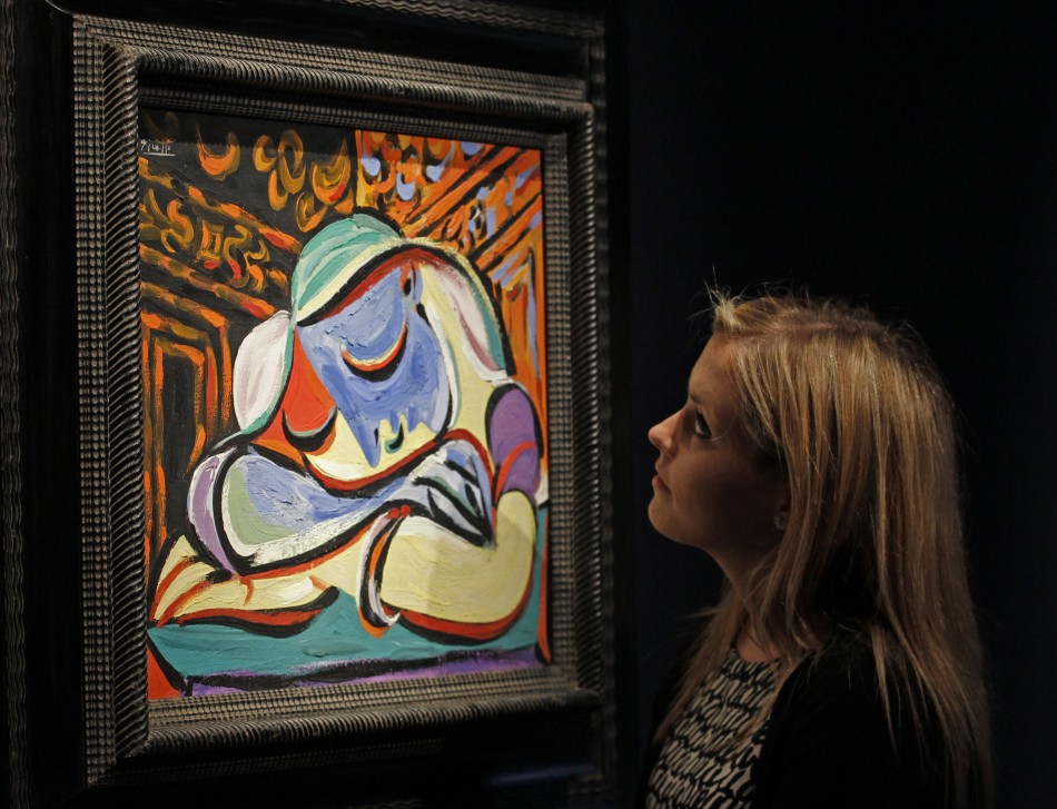 A employee poses with Pablo Picassos quotJeune fille endormiequot at Christies auction house in London