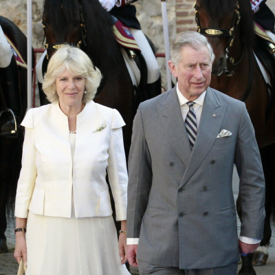 Britain's Prince Charles walks next to his wife Camilla