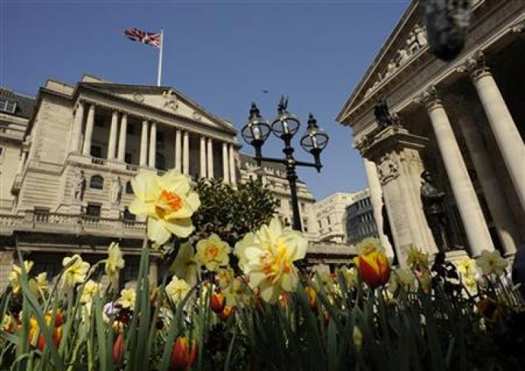 The Bank of England is seen behind blossoming flowers in the City of London