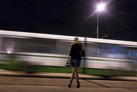 A prostitute waits for clients on a street in the outskirts of Moscow