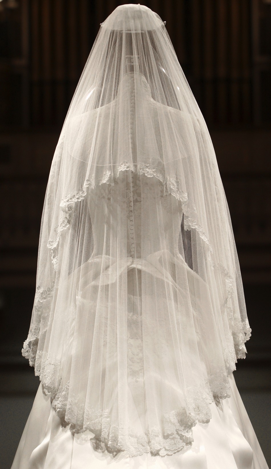 The wedding dress of Britain039s Catherine, Duchess of Cambridge is seen as it is prepared for display at Buckingham Palace in London