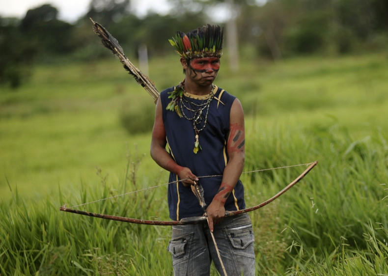 A member of the Guarani tribe watch at a roadblock they built to keep farmers out after they occupied a farm they claim is part of their ancestral land in Mato Grosso do Sul state, Brazil. (Reuters)