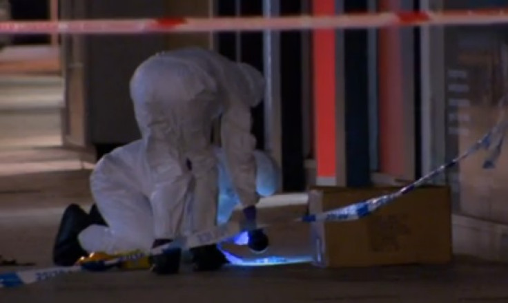 Police forensic team comb area in Cornmarket, Belfast targeted by a firebomber