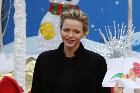 Princess Charlene of Monaco poses with children during the traditional Christmas tree ceremony at the Monaco Palace as part of Christmas holiday season in Monaco December 18, 2013.