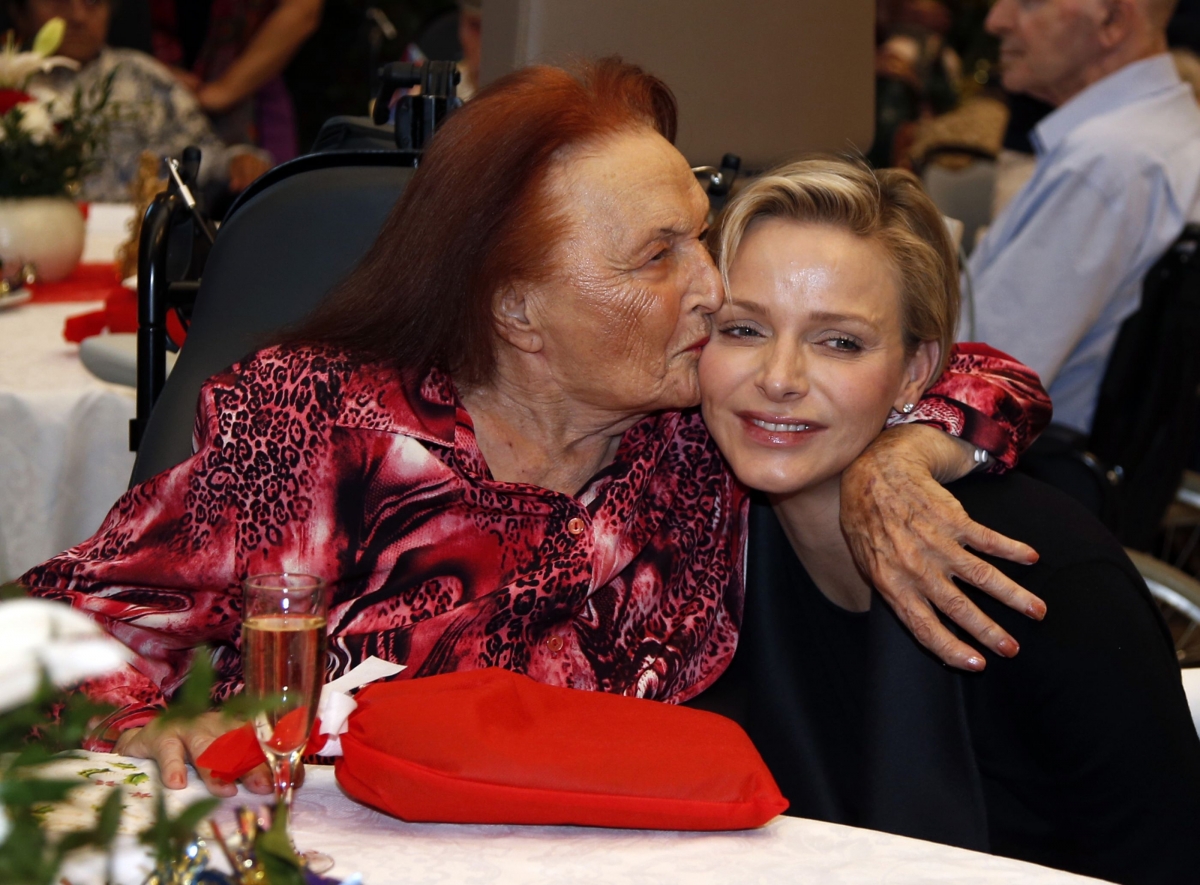 Princess Charlene of Monaco is kissed by a woman during a gift ceremony in the gerontology service at the Princess Grace Hospital.