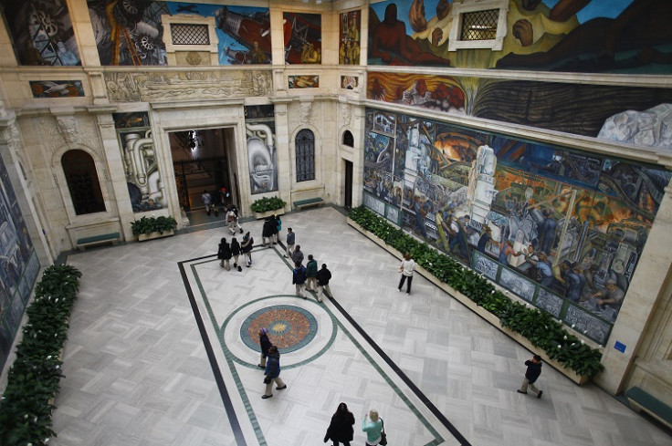 People at a mural by artist Diego Rivera at the Art Institute of Detroit in Detroit, Michigan December 3, 2013