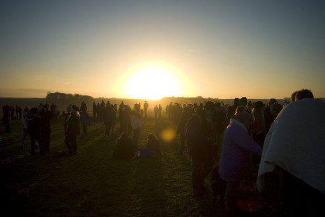 Revellers gather as they enjoy the sunrise during the winter solstice at Stonehenge.