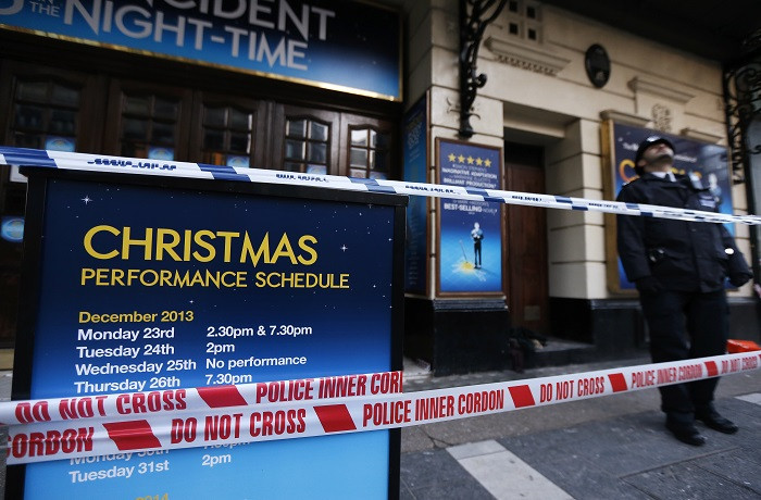A police officer stands on duty outside the Apollo Theatre on the morning after part of the building's ceiling collapsed.