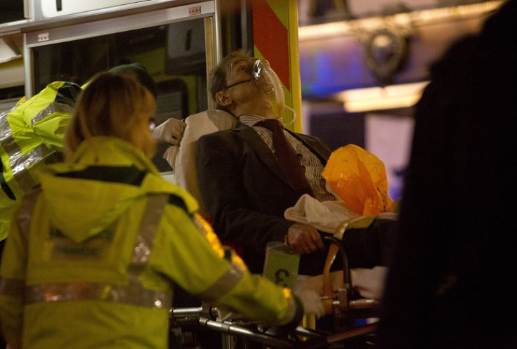 A man injured during the Apollo Theatre's ceiling collapse receives medical attention from paramedics.