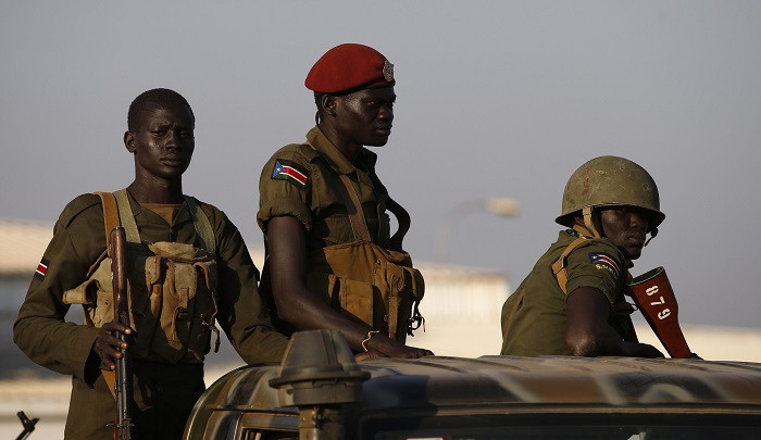 South Sudan government soldiers stand guard in Juba. Current inter-ethnic clashes have been blamed on disputes between Dinka and Nuer members of the presidential guard.