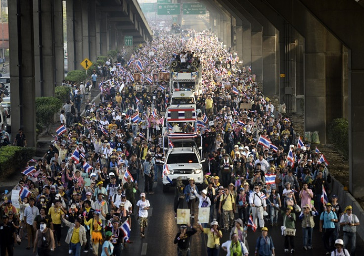 Thousands of demonstrators march through Bangkok's streets shouting anti-government slogans.