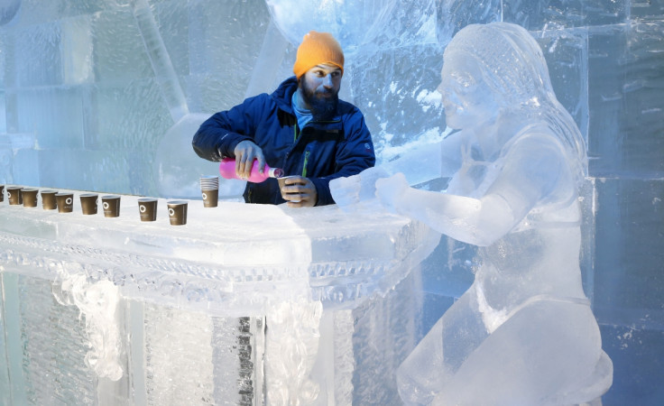 The Ice Maiden Cometh. Sculptor Jonathan Bouchard of Canada poses near a sculpture at the ice bar of the Brussels Ice Magic Festival. Some 20 artists from all over the world made sculptures out of 420 tonnes of ice depicting characters from comic strips.