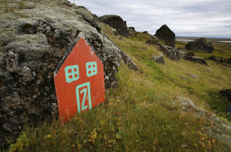 A painted elf door leans against rocks near the Icelandic town of Selfoss