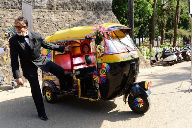 71-year-old AMitabh Bachchan looks dashing in tuxedo and shades as he readies for an auto rickshaw ride.