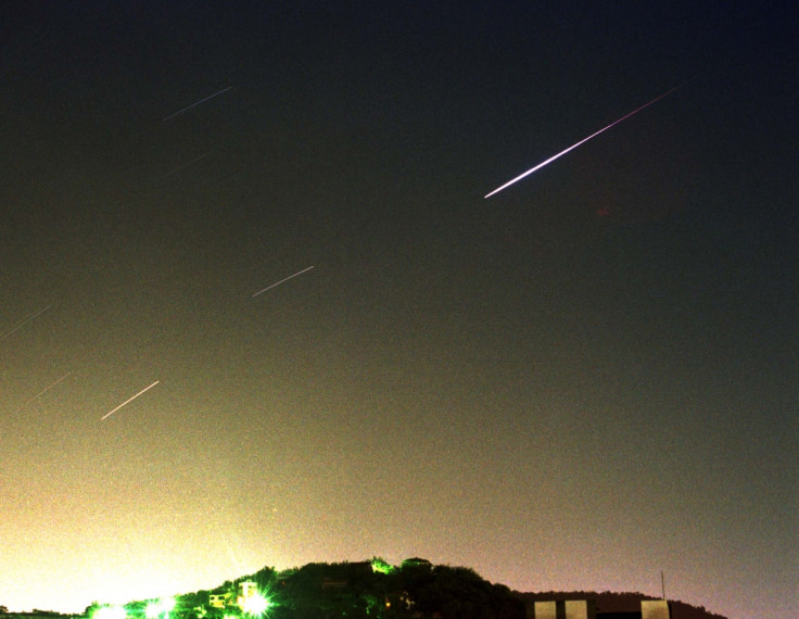 A meteor streaks across the night sky.