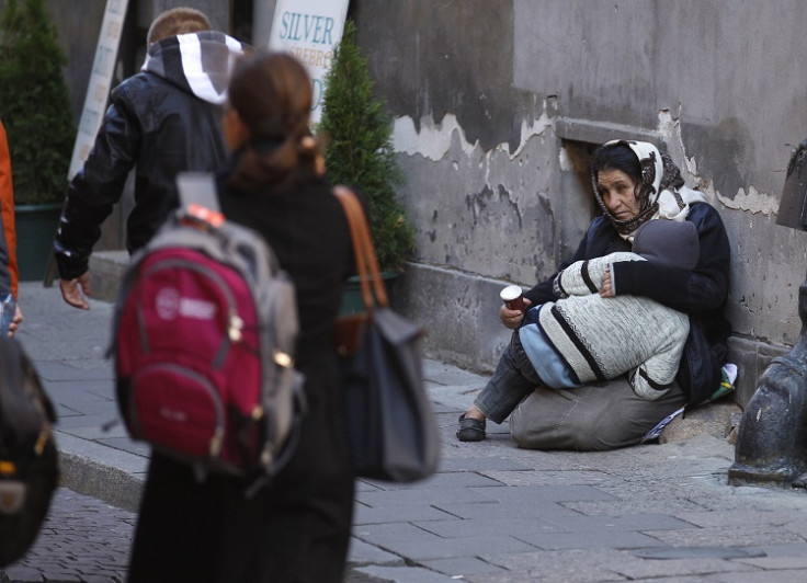 A Roma woman and her child beg for money