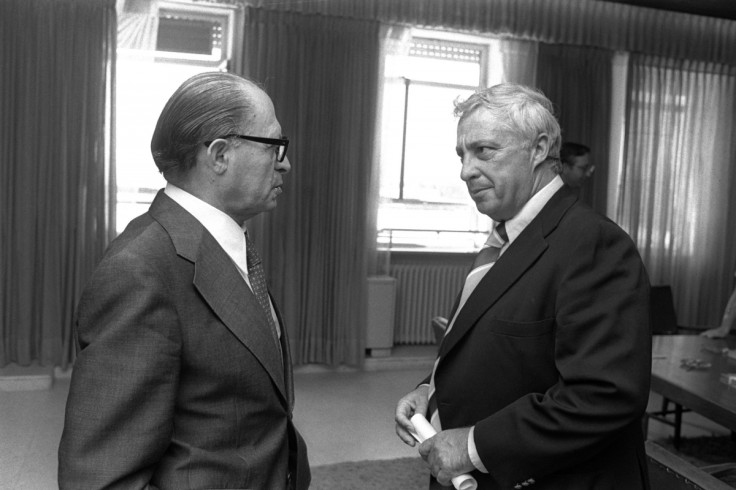 Israeli Prime Minister Menahem Begin (L) speaks with Ariel Sharon