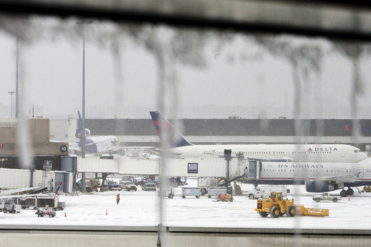 Icicles on a window are seen in front of airplanes during a winter nor'easter snow storm in Boston.