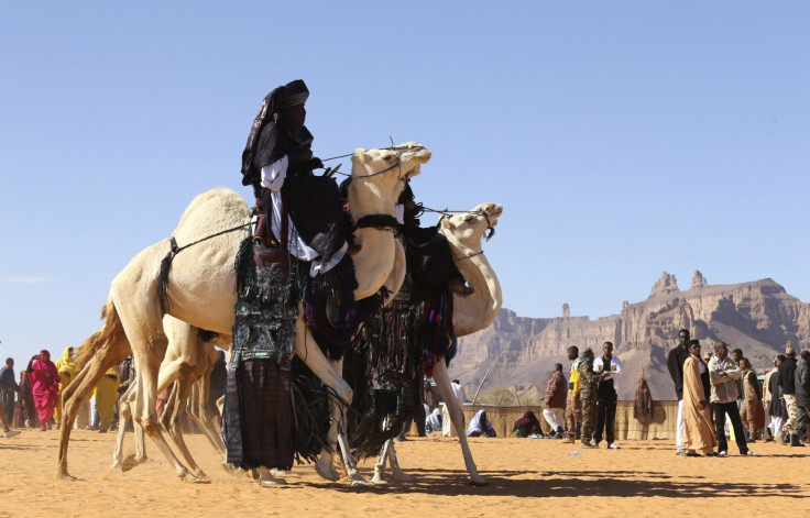 Tuareg men ride camels in the desert during the 19th Ghat Festival of Culture and Tourism.