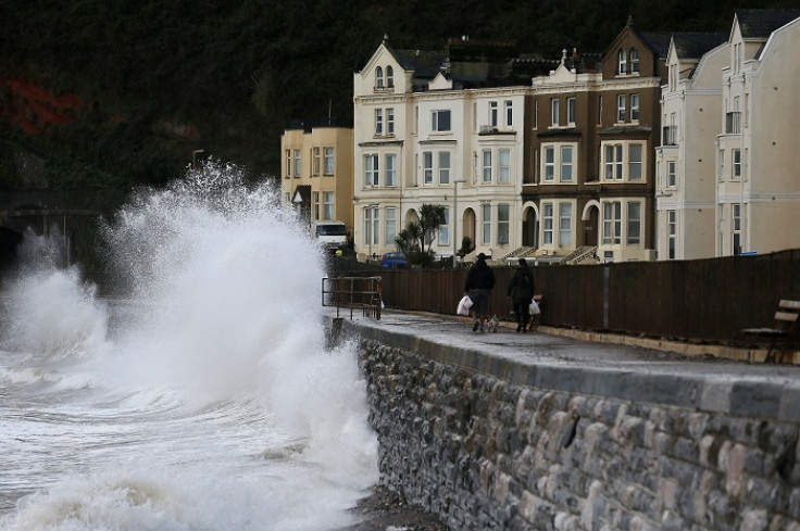 Waves crash against the promenade in Devon, south-east England.