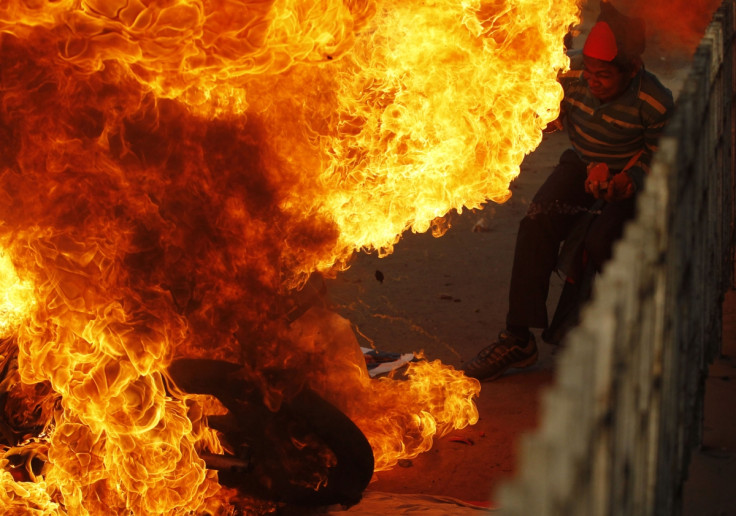 A pro-government activist sets fire to a motorcycle during a clash with Bangladesh National Party protesters in Dhakha on December 29.