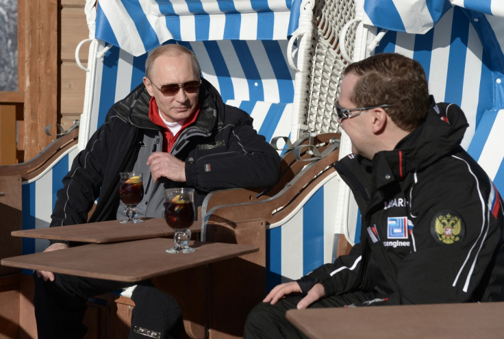 Russian President Vladimir Putin (L) and Prime Minister Dmitry Medvedev chat during their visit to the "Laura" cross country ski and biathlon centre in the resort of Krasnaya Polyana near Sochi January 3, 2014.