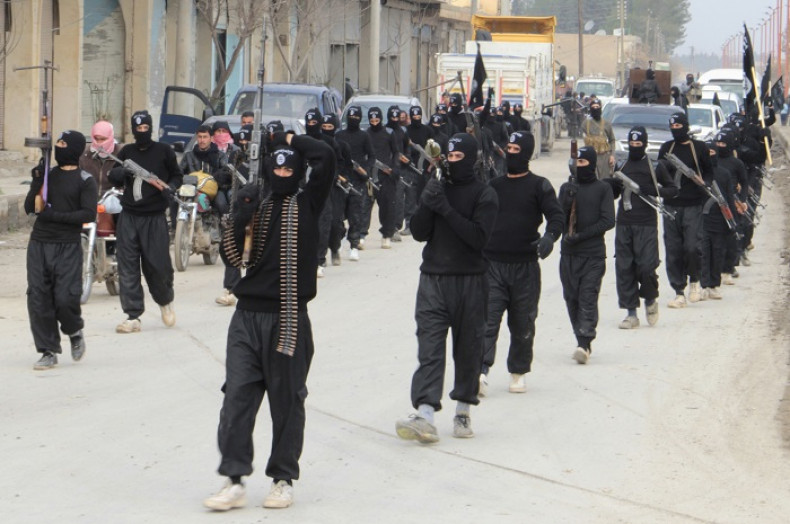 Isil fighters parade the streets of the Syrian town of Tel Abyad.