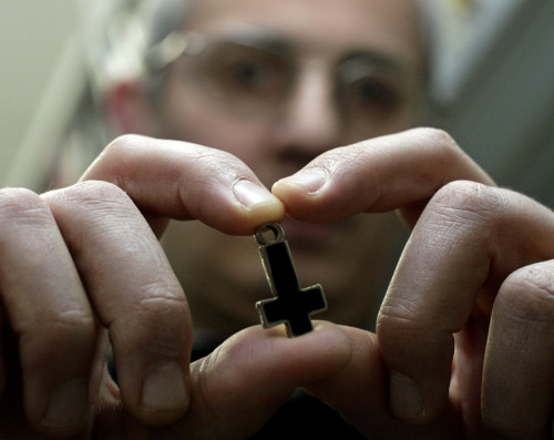 Professor at Rome's Regina Apolostolorum pontifical university holds an inverted cross used by Satanic worshippers. Professor at Rome's Regina Apolostolorum pontifical university holds an inverted cross used by Satanic worshippers.