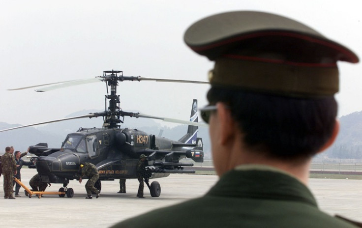 A Chinese officer looks on at a helicopter in the southern Chinese city of Zhuhai.