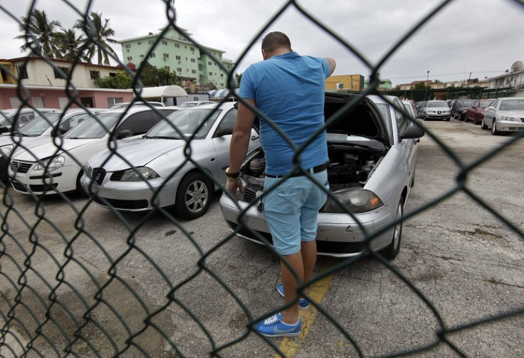 A man inspects a used car for sale at a vehicle dealership in Cuba's capital Havana.