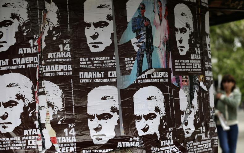 A woman walks past election posters of Volen Siderov, leader of the Attack party, in Sofia
