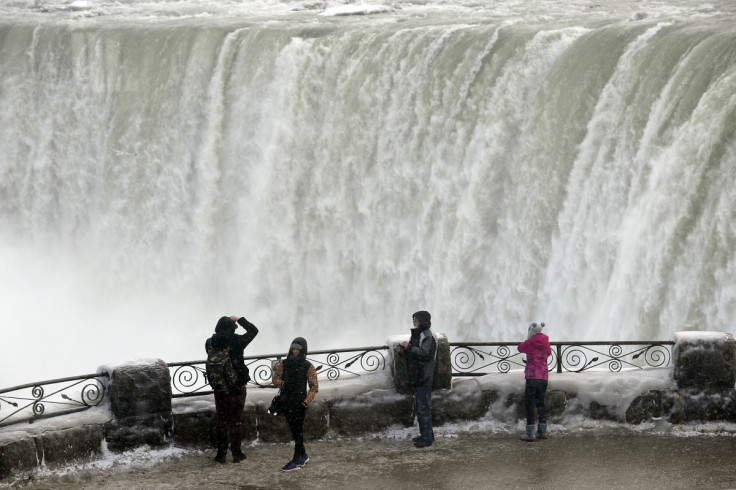 Visitors take pictures overlooking the falls in Niagara Falls, Ontario, January 8, 2014.