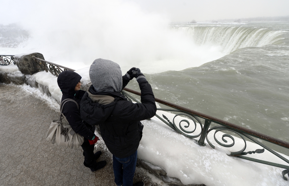 Visitors enjoy the frozen view of Niagara Falls in bitter cold.