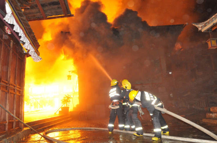 Firefighters spray water as they try to extinguish a fire at the Dukezong Ancient Town.