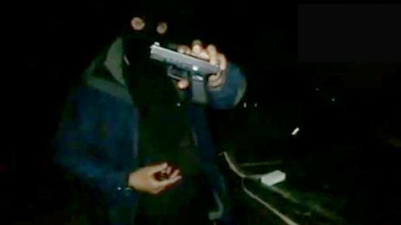 A British jihadist shows off his Glock pistol in a video posted on YouTube.