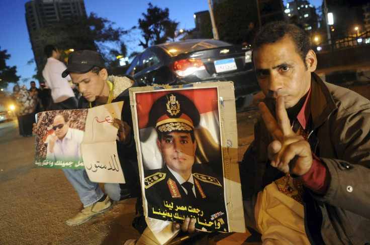 Egyptians hold pictures of Egypt's Army Chief General Abdel Fattah al-Sisi