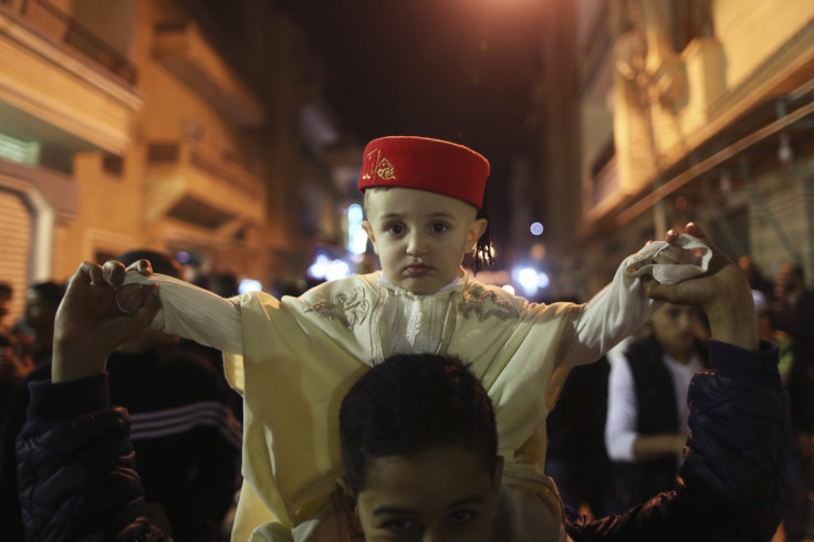 A child wearing a traditional costume takes part in a procession to celebrate the birth of Prophet Mohammad in Benghazi January 12, 2014.