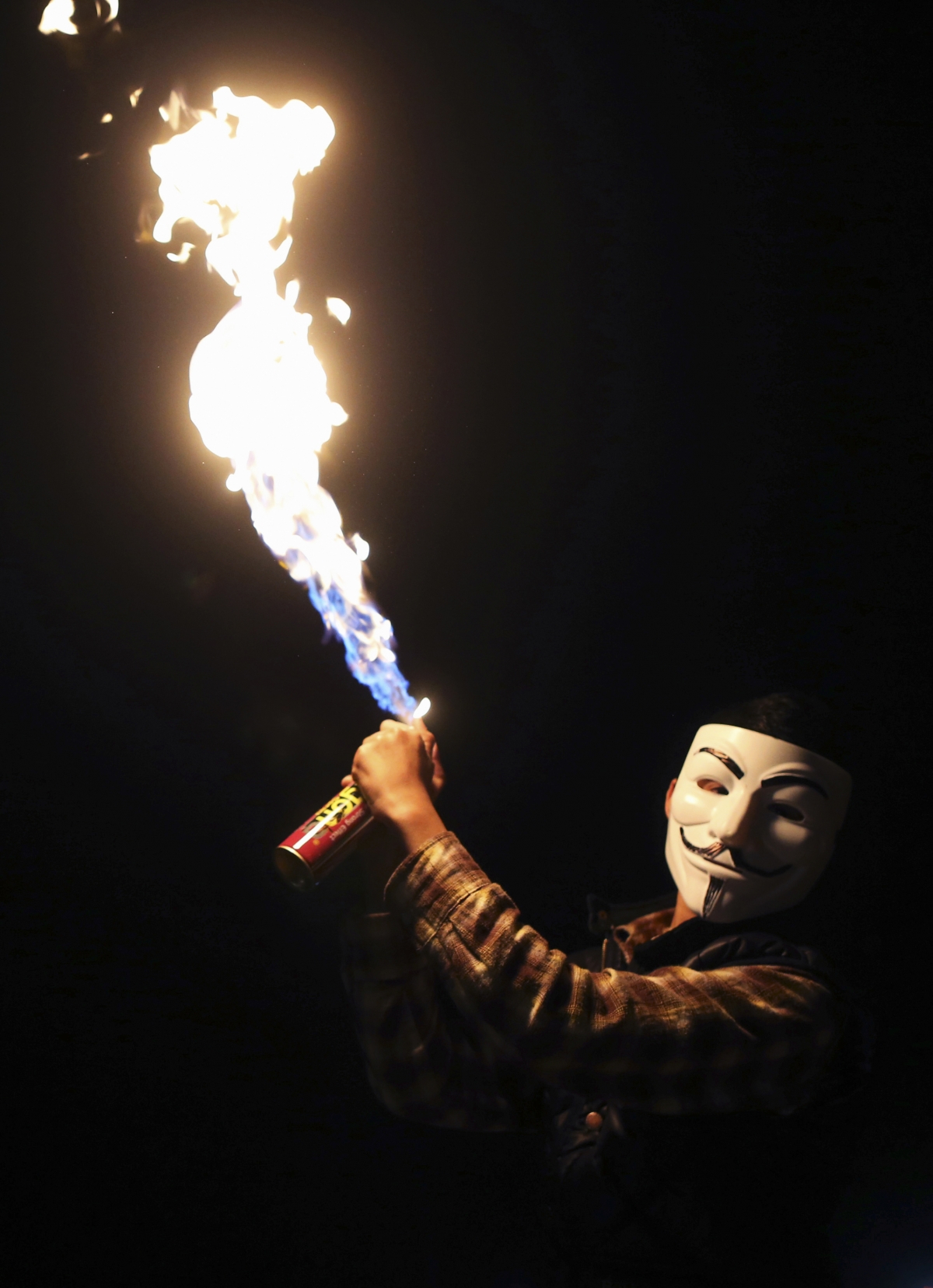 A boy wearing a Guy Fawkes mask celebrates the birth of Prophet Mohammad during a procession in Libya.