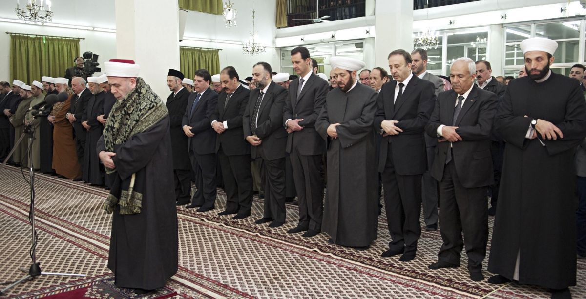 Syrias President Bashar al-Assad 5th R prays during a religious ceremony to commemorate Prophet Mohammads birthday at al-Hamd mosque in Damascus January 12, 2014.