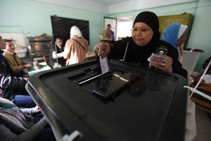 Women cast their votes at a polling centre during a referendum on Egypt's new constitution in Cairo