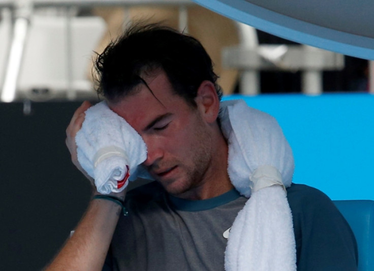 Adrian Mannarino of France holds an ice pack to his face during his men's singles match against David Ferrer of Spain