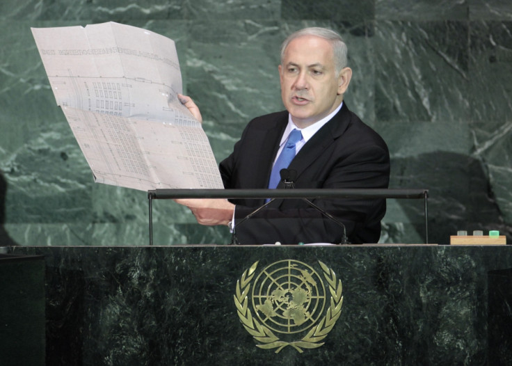 Israeli Prime Minister Benjamin Netanyahu holds up a document outlining plans for the Auschwitz death camp