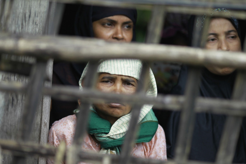Rohingya Muslim women look out from their home at Aung Mingalar quarter in Sittwe