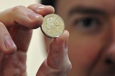 George Osborne holds coin